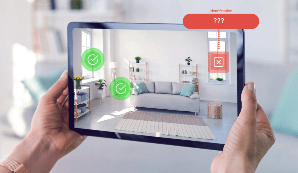 a hand holding a tablet with a picture of a living room