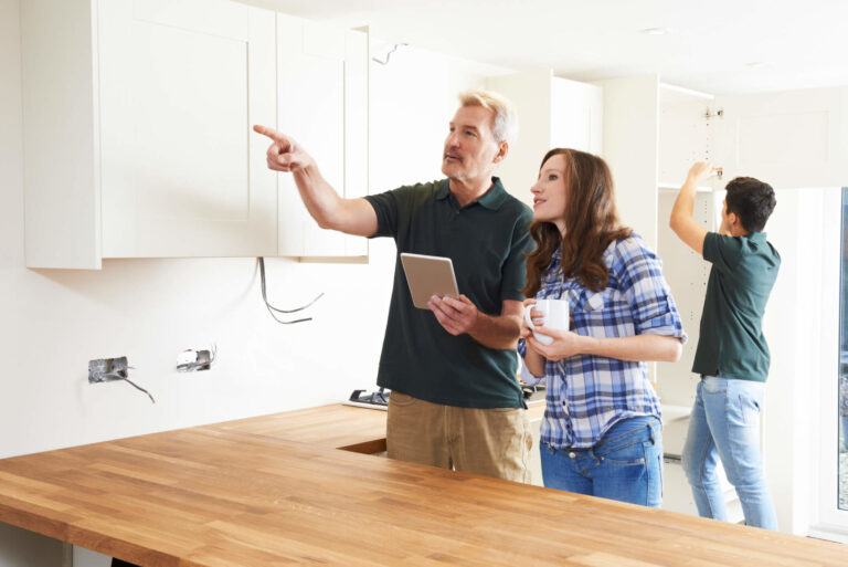 a group of people standing in a kitchen