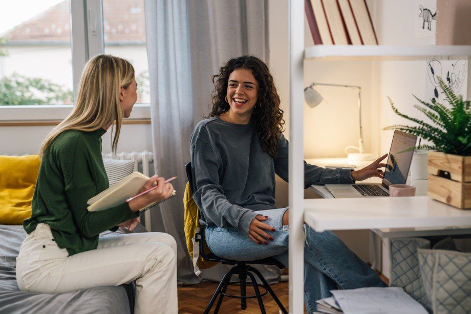 Two students smiling together in student accommodation